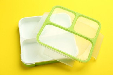 Photo of Empty plastic lunch box on yellow background