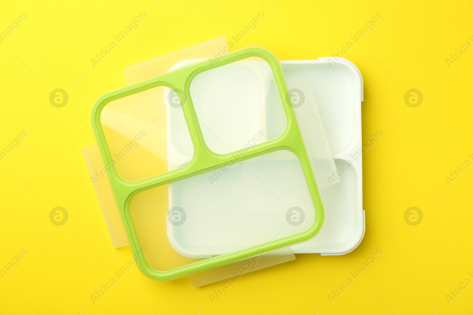 Photo of Empty lunch box on yellow background, top view