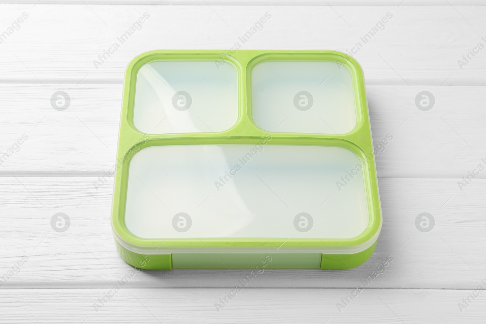 Photo of Empty lunch box on white wooden table