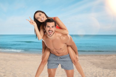 Happy couple spending their honeymoon at sea. Newlyweds having fun on sandy beach