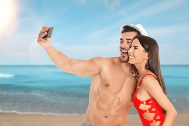 Image of Happy newlyweds taking selfie at sea on honeymoon