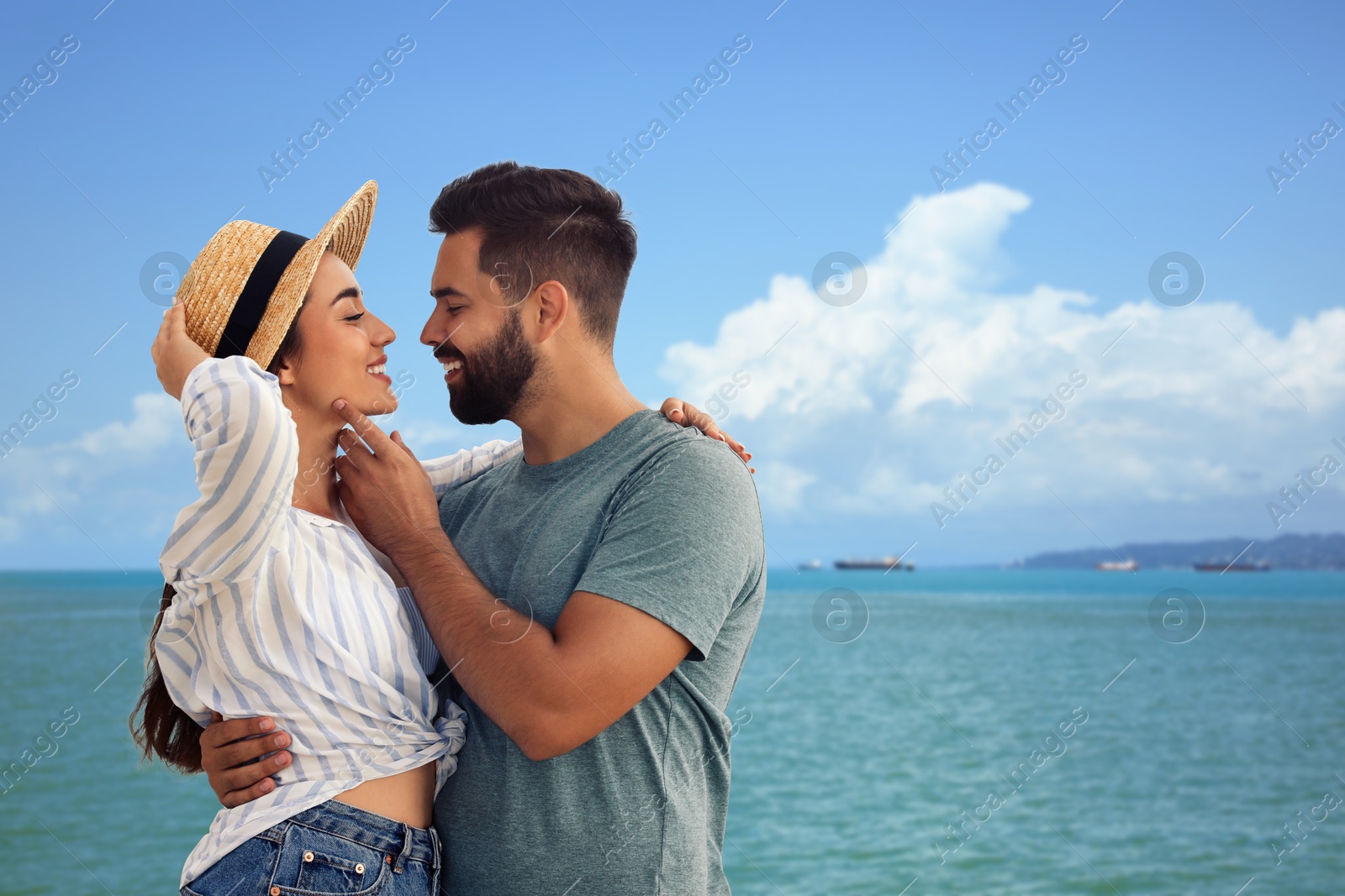 Image of Happy newlyweds enjoying their honeymoon. Couple smiling near sea