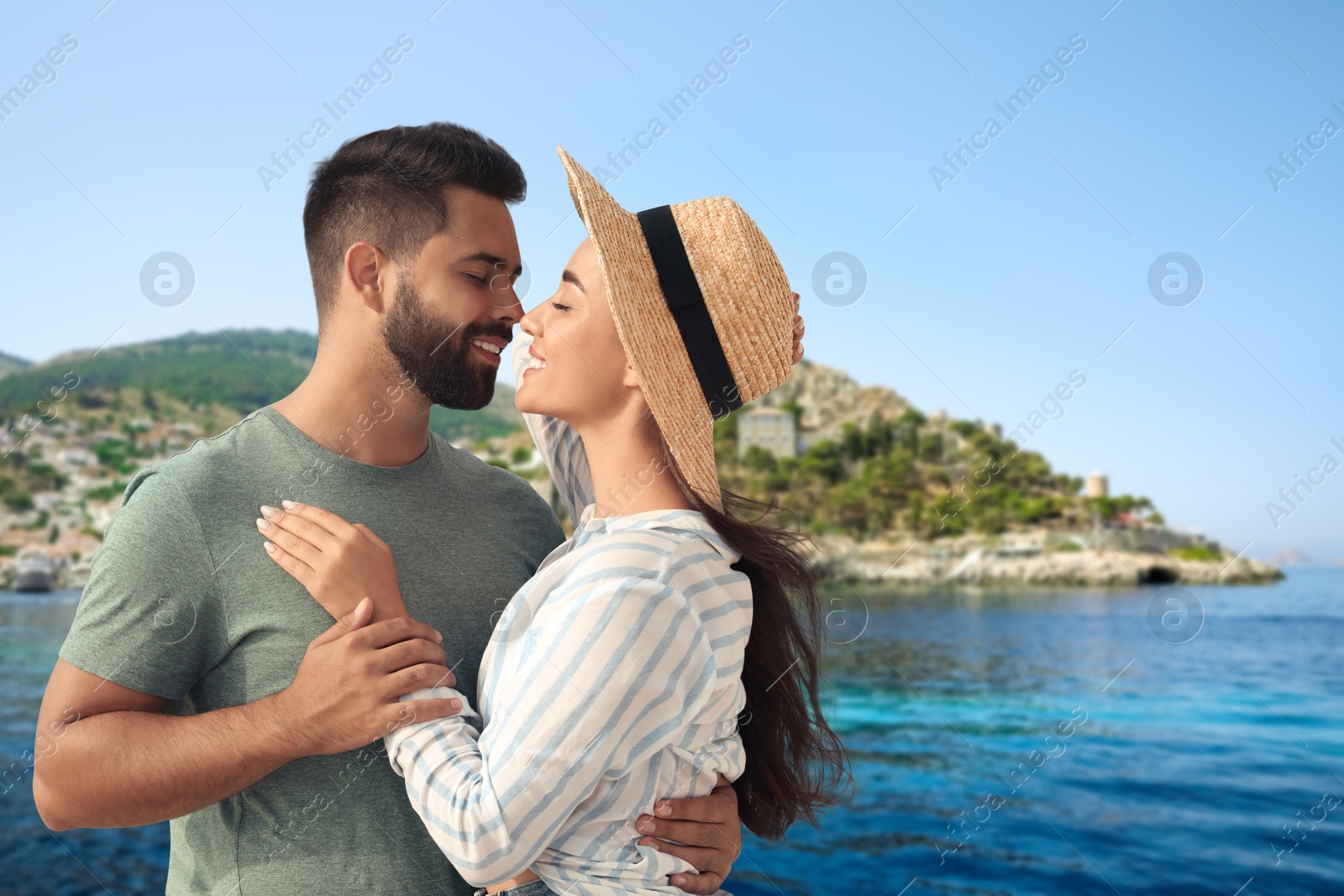 Image of Happy newlyweds enjoying their honeymoon. Couple smiling near sea