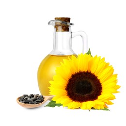 Image of Cooking oil in glass jug, sunflower seeds and flower isolated on white