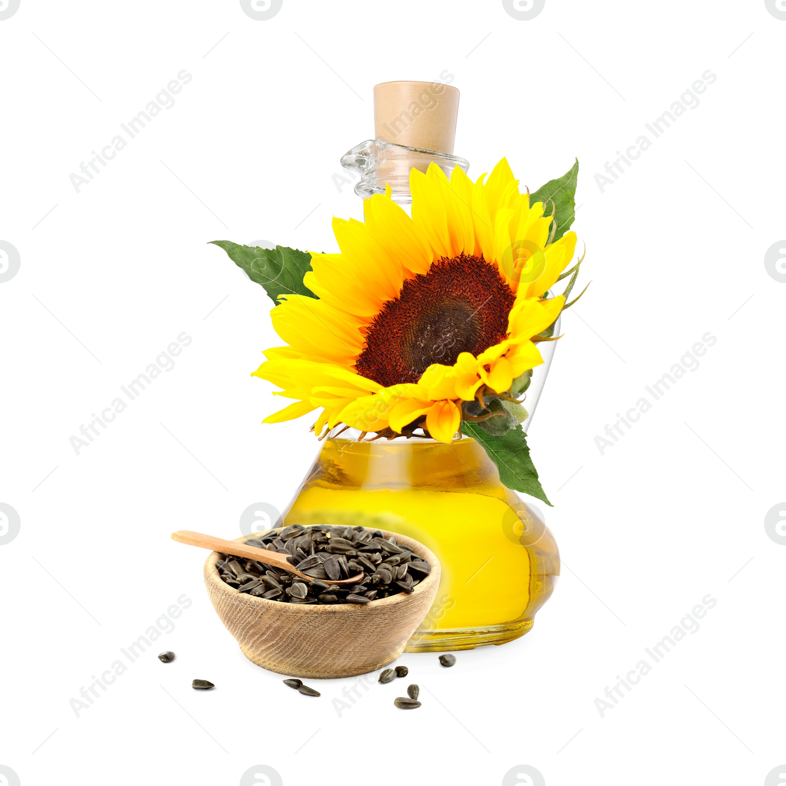 Image of Cooking oil in glass jug, sunflower seeds and flower isolated on white