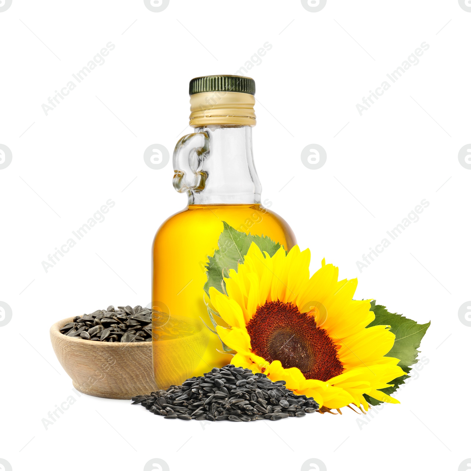 Image of Cooking oil in glass bottle, sunflower seeds and flower isolated on white