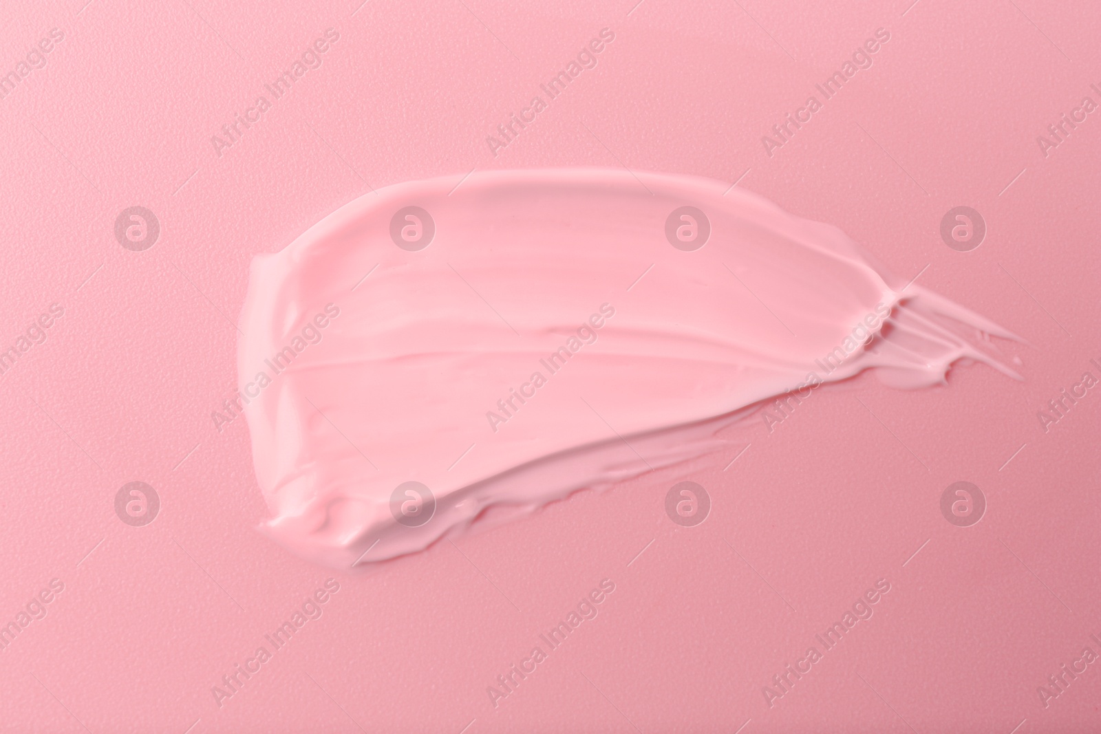 Image of Sample of face cream on pink background, top view