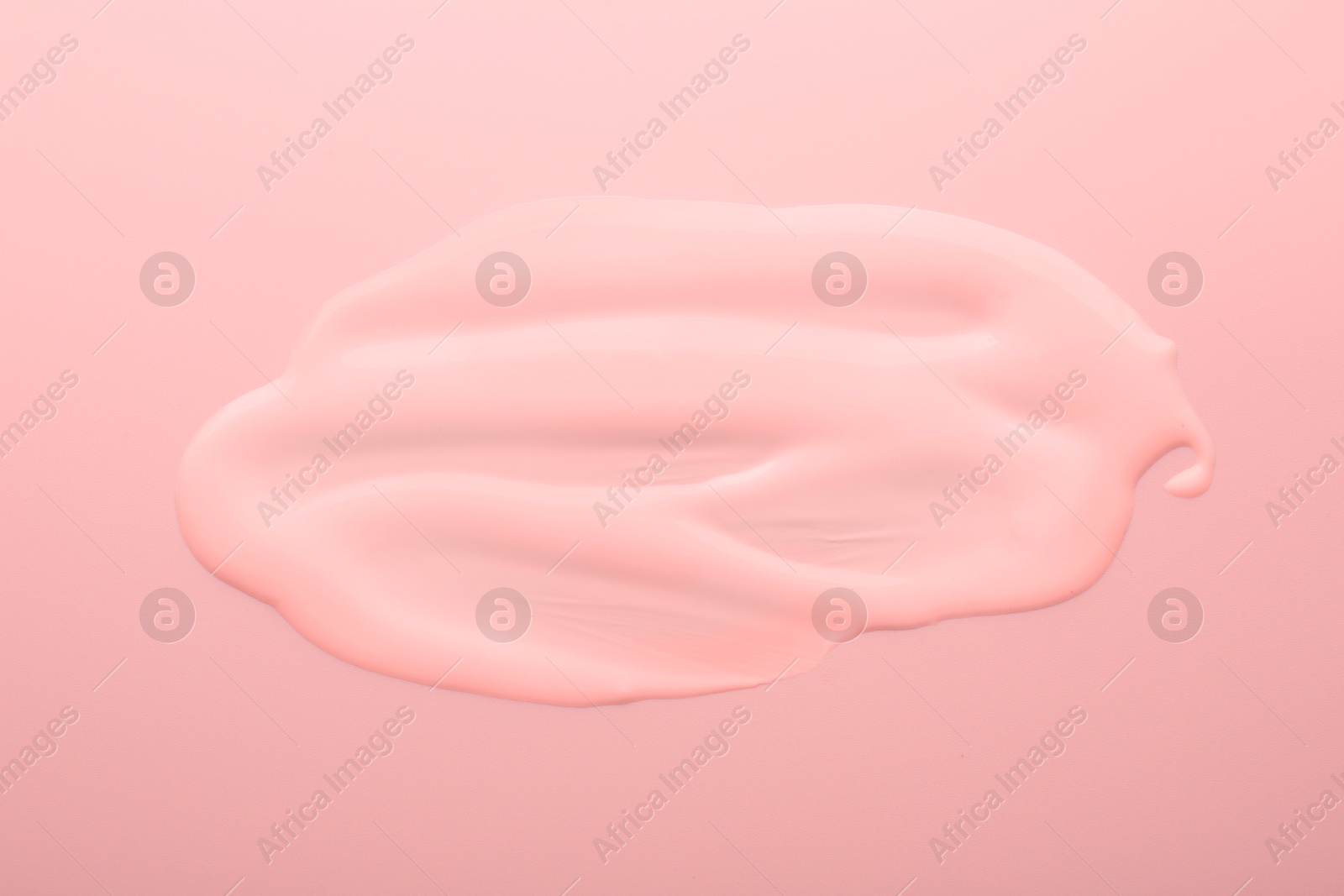 Image of Sample of face cream on pink background, top view