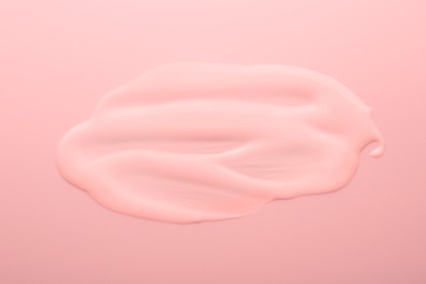 Image of Sample of face cream on pink background, top view