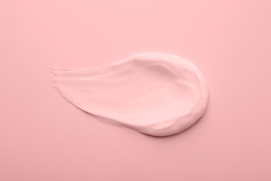 Image of Sample of face cream on pink background, top view