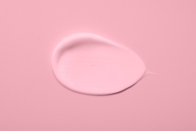 Image of Sample of face cream on pink background, top view