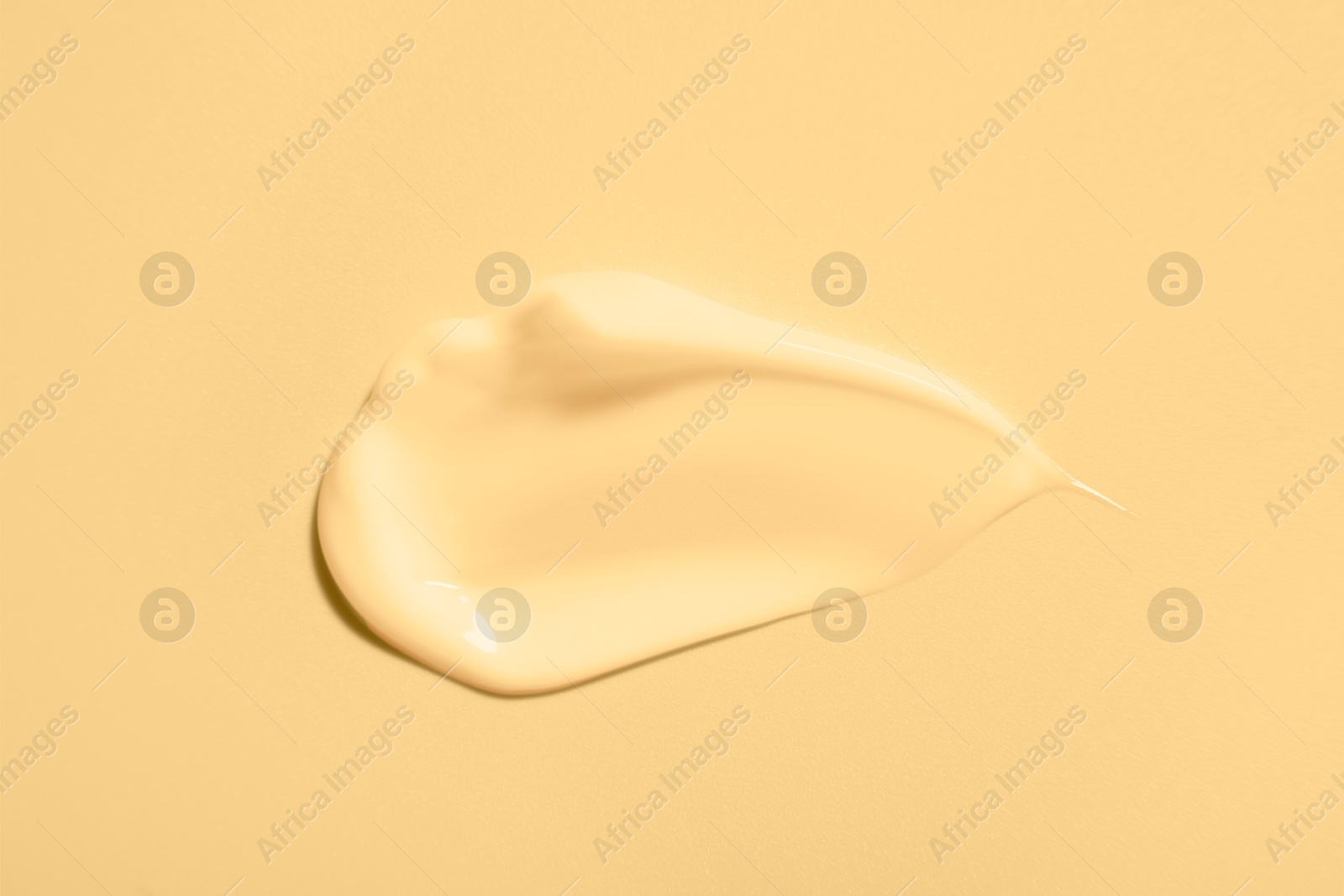 Image of Sample of face cream on beige background, top view