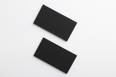 Blank business cards on light grey background, top view. Mockup for design