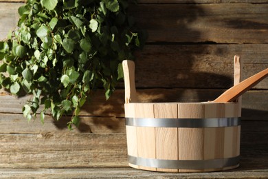 Sauna equipment. Bucket and ladle on wooden surface