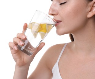 Photo of Woman drinking water with lemon on white background, closeup