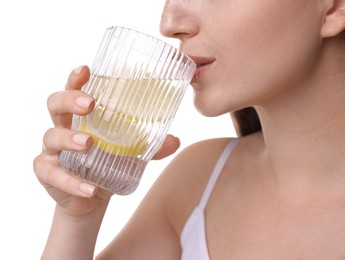 Woman drinking water with lemon on white background, closeup