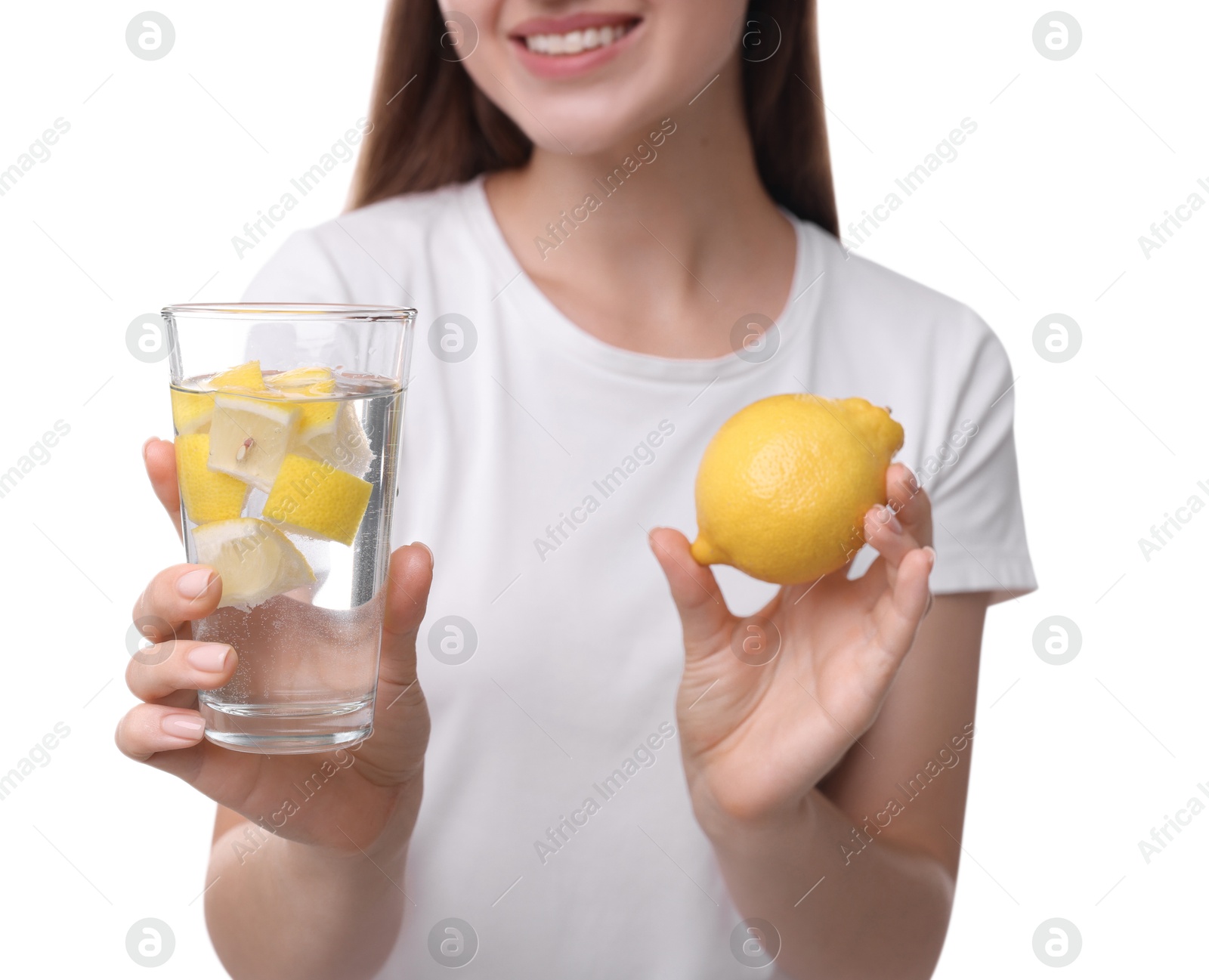 Photo of Woman with glass of lemon water and fruit on white background, closeup