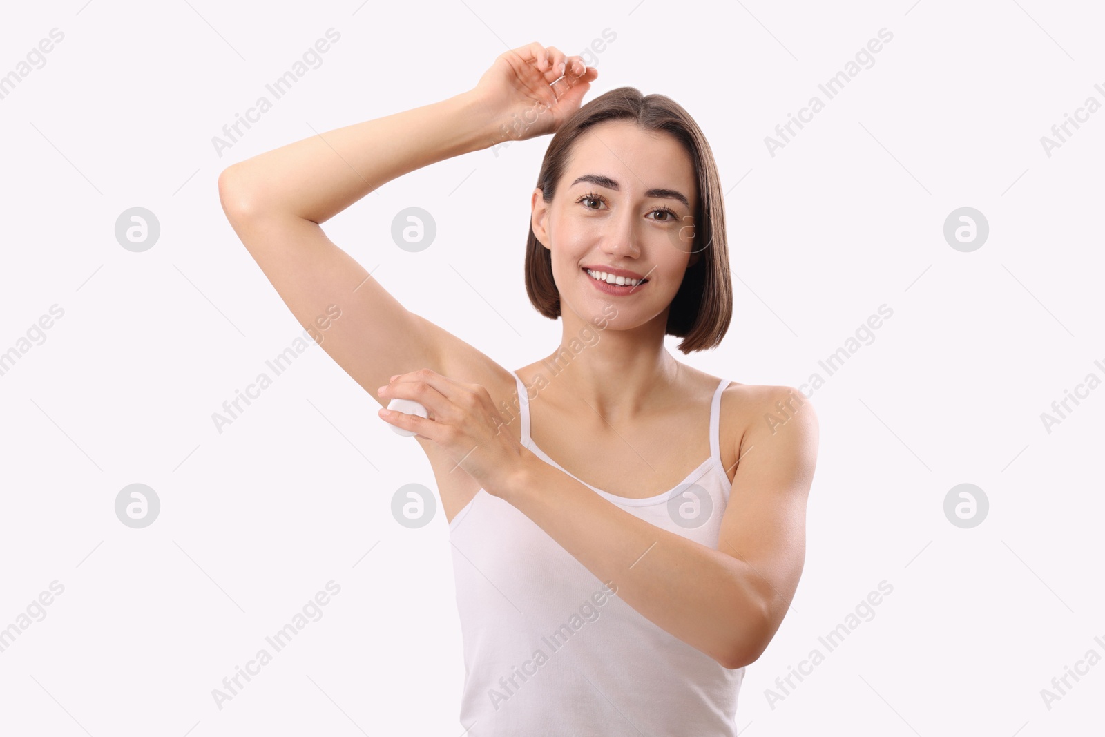 Photo of Smiling woman applying deodorant on white background