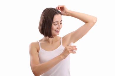 Photo of Smiling woman applying roll-on deodorant on white background