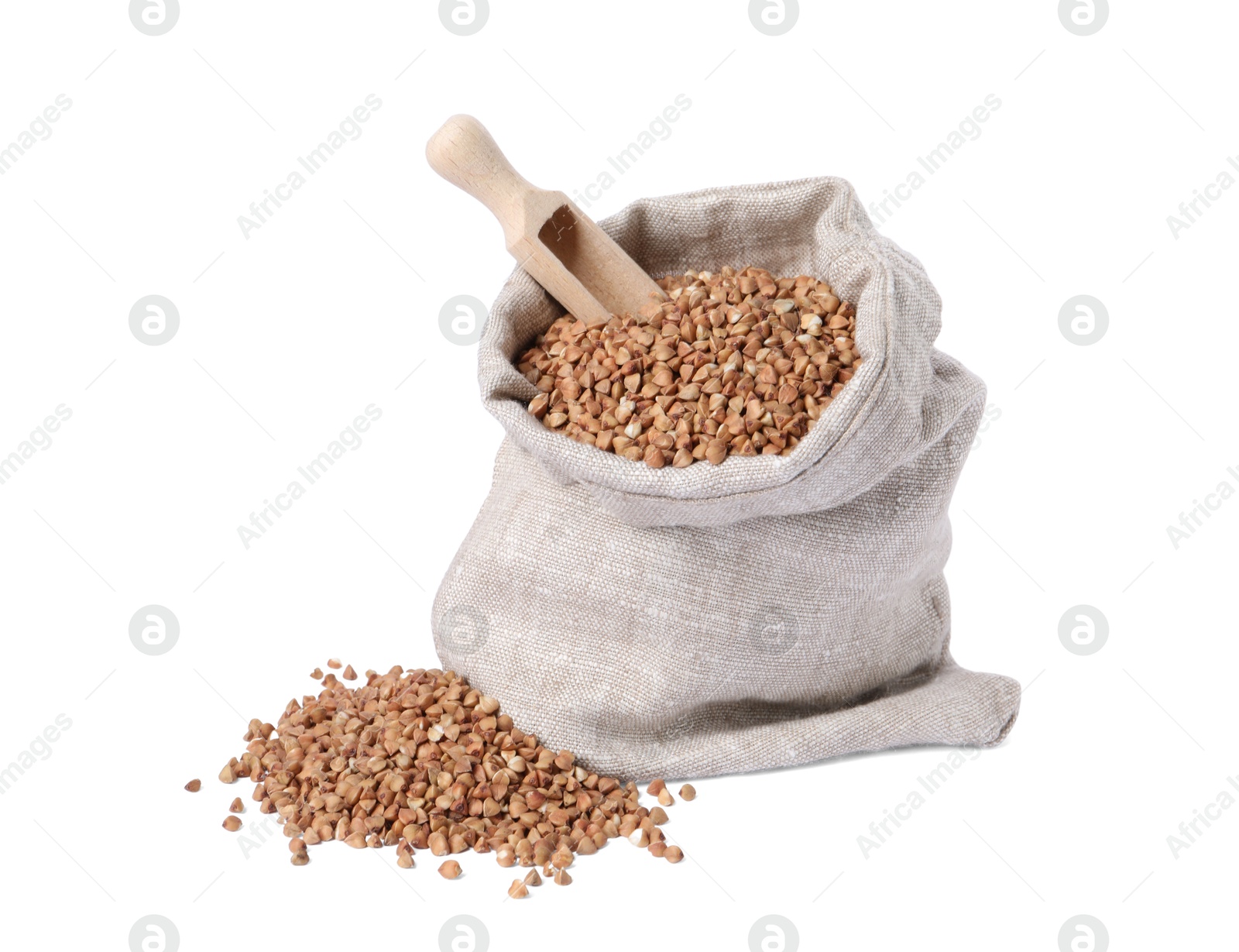 Photo of Raw buckwheat in burlap with scoop isolated on white