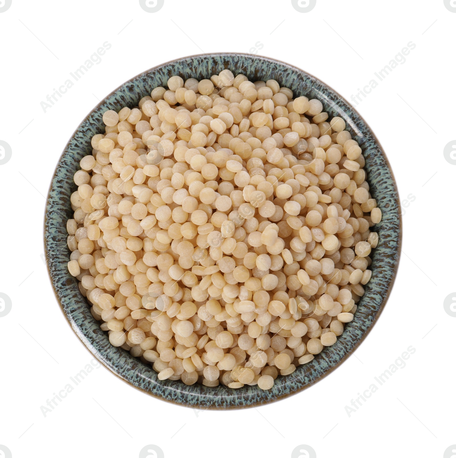 Photo of Raw couscous in bowl isolated on white, top view