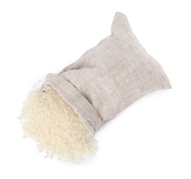 Photo of Raw rice and overturned burlap sack isolated on white, top view