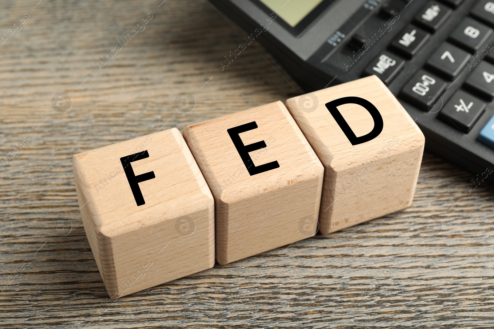 Photo of Cubes with letters Fed (Federal Reserve System) on wooden table