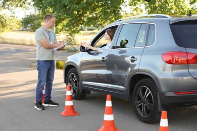 Woman passing maneuverability driving test on track