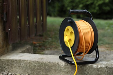 Extension cord reel in backyard. Electrician's equipment