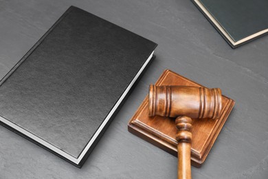 Book and judge's gavel on gray textured table