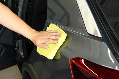 Photo of Man wiping auto with rag at car wash, closeup