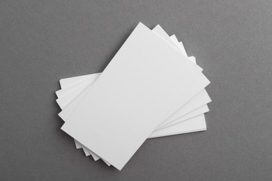 Blank business cards on grey background, top view. Mockup for design