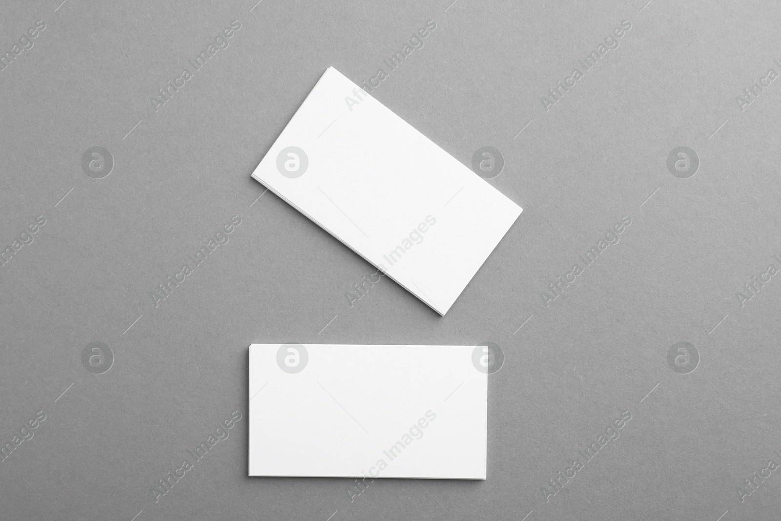 Photo of Blank business cards on grey background, top view. Mockup for design