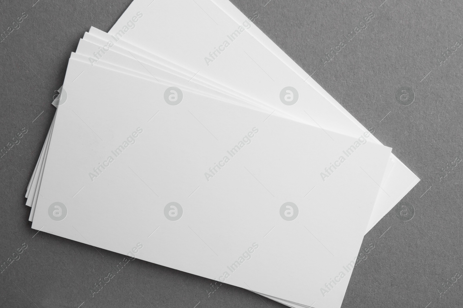 Photo of Blank business cards on grey background, top view. Mockup for design