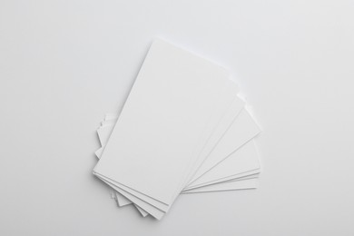 Photo of Blank business cards on light grey background, top view. Mockup for design