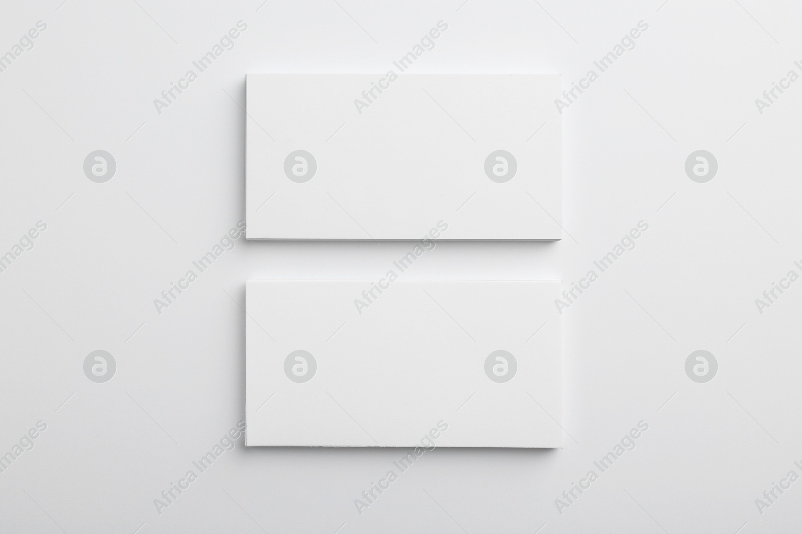 Photo of Blank business cards on light grey background, top view. Mockup for design