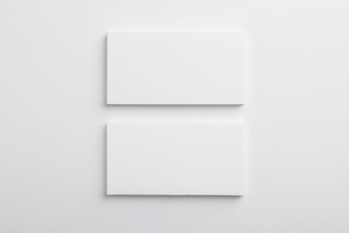 Blank business cards on light grey background, top view. Mockup for design