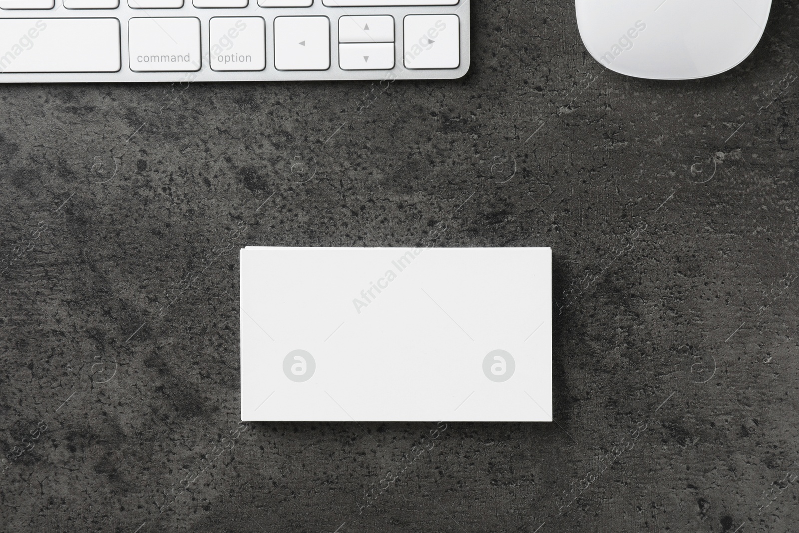 Photo of Blank business cards, computer mouse and keyboard on grey textured table, flat lay. Mockup for design