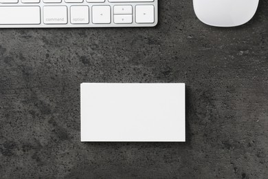 Photo of Blank business cards, computer mouse and keyboard on grey textured table, flat lay. Mockup for design