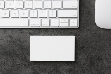 Photo of Blank business cards, computer mouse and keyboard on grey textured table, flat lay. Mockup for design