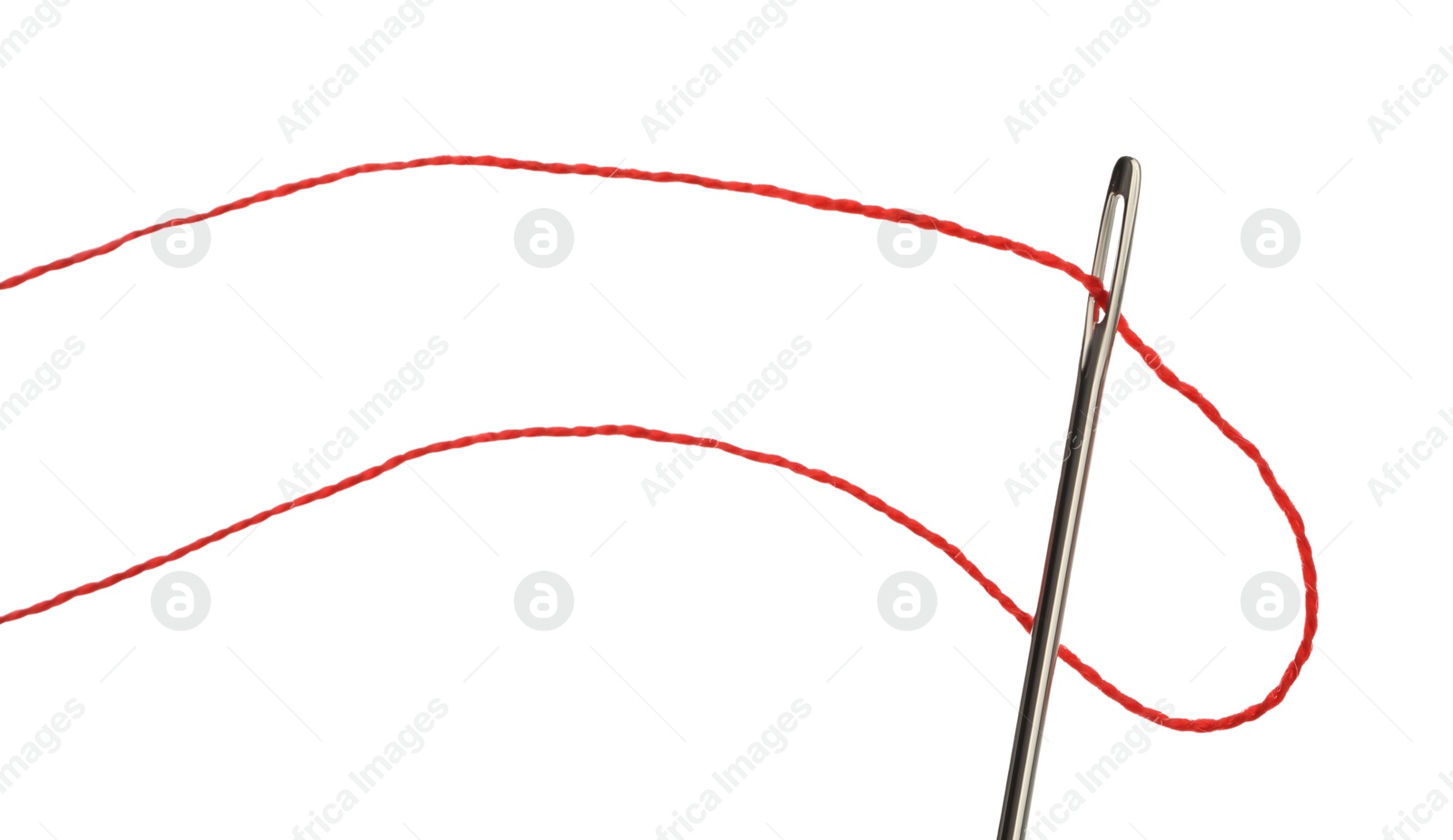 Photo of Sewing needle with red thread isolated on white