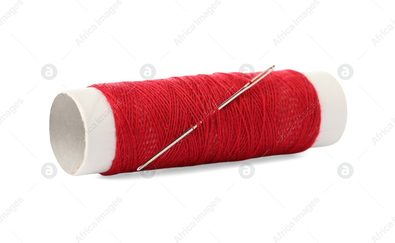 Photo of Spool of red sewing thread with needle isolated on white