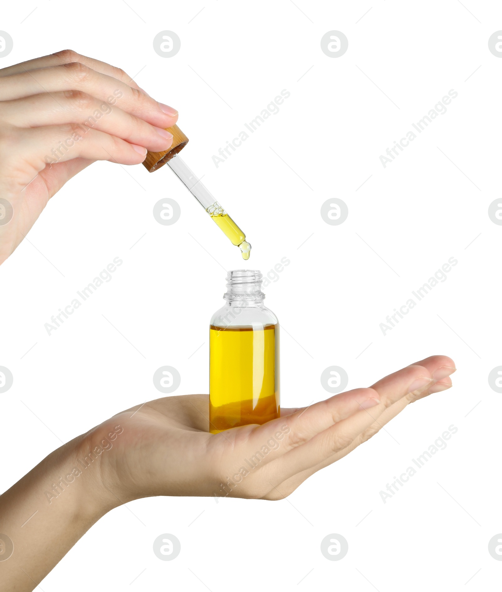 Photo of Woman dripping tincture from pipette into bottle against white background, closeup