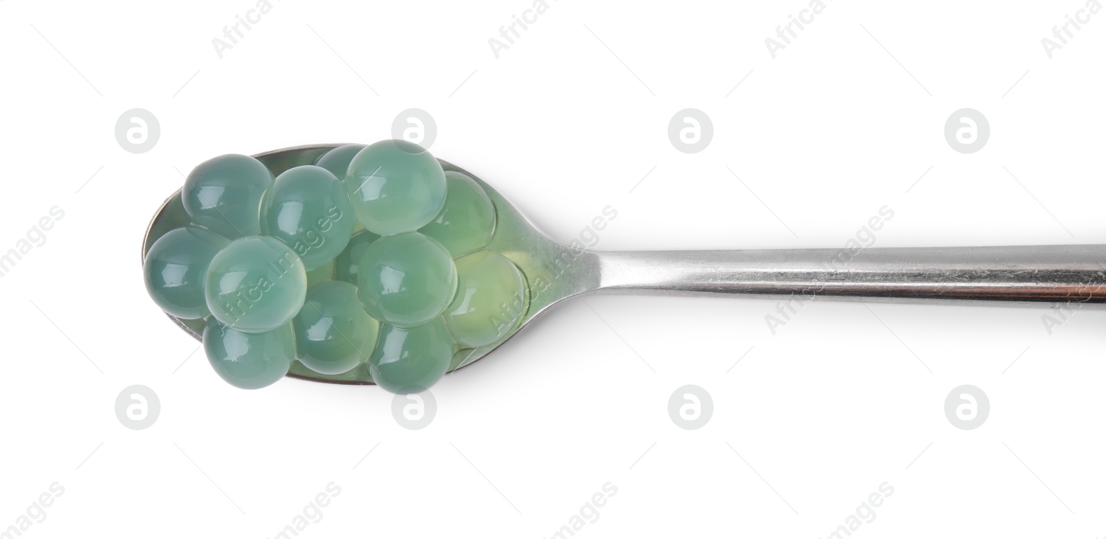 Photo of Bright tapioca pearls in spoon isolated on white, top view