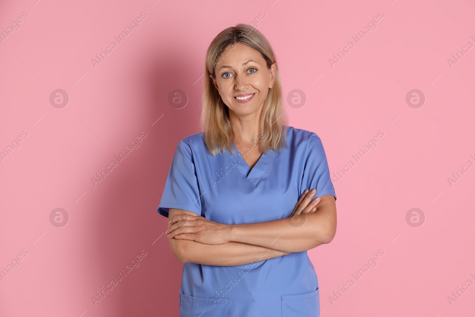 Photo of Portrait of nurse in medical uniform on pink background