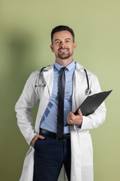 Smiling doctor with stethoscope and clipboard on olive background