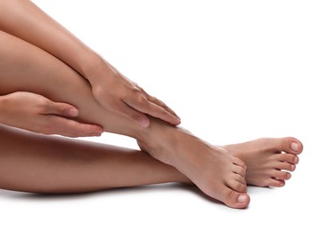 Photo of Woman touching her smooth legs on white background, closeup