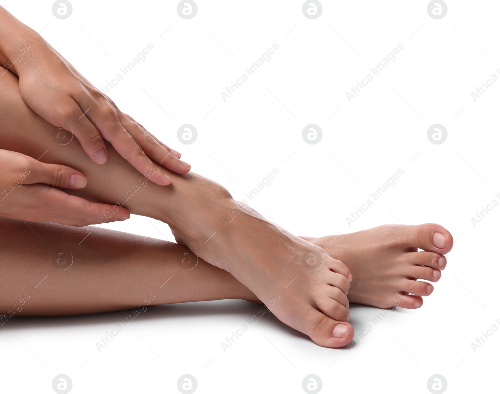 Photo of Woman touching her smooth legs on white background, closeup