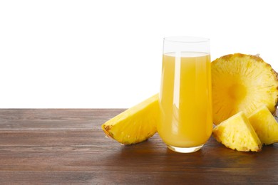 Photo of Glass with pineapple juice and pieces of fresh fruit on wooden table against white background