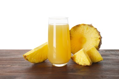 Photo of Glass with pineapple juice and pieces of fresh fruit on wooden table against white background